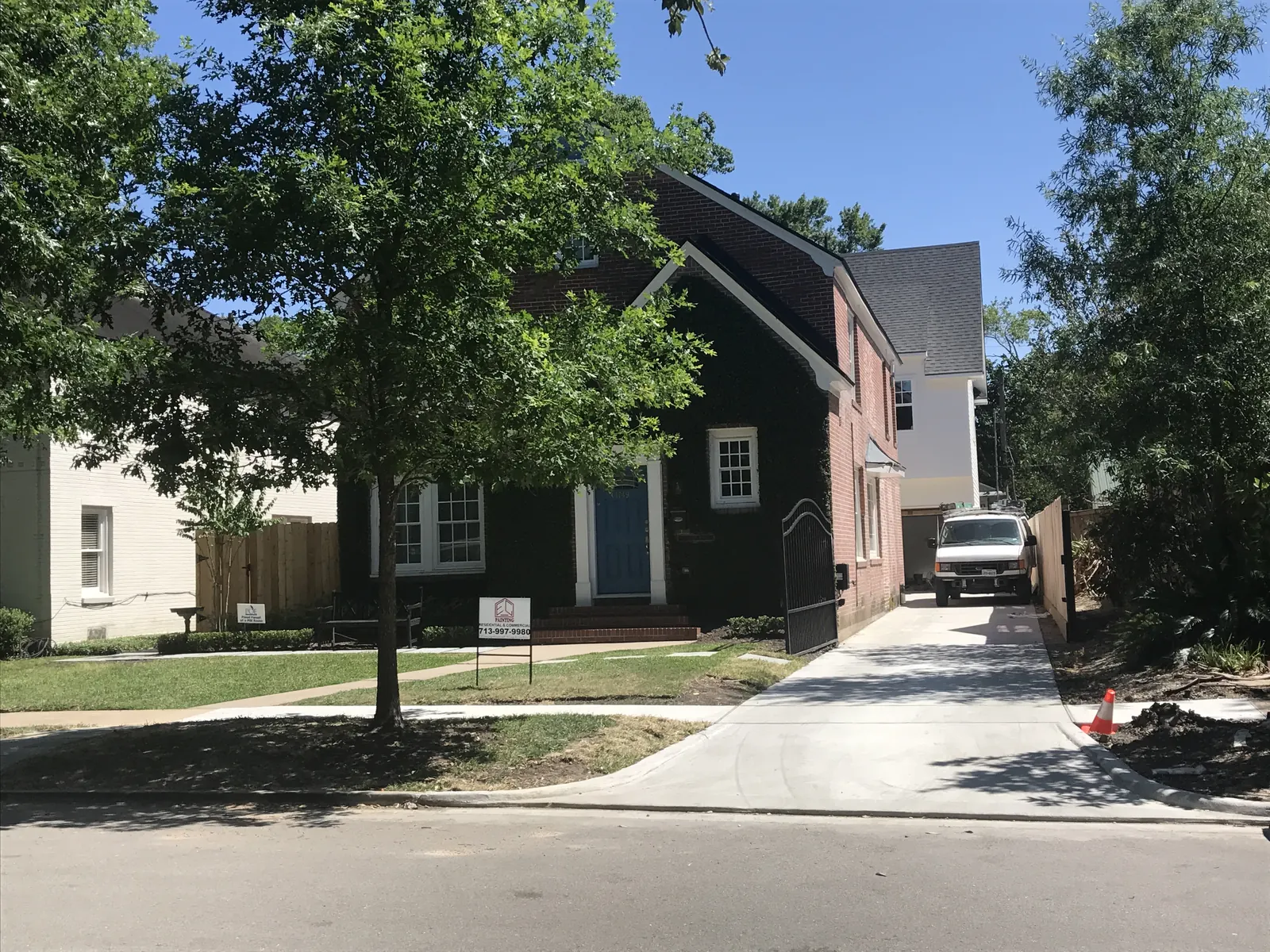 Two-story home exterior on an EC Painting job site with the company van in the driveway